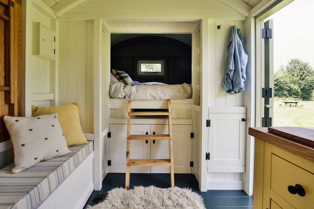  Interior photography of shepherds hut guest room cabin bed area 
