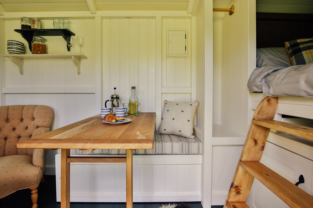  Interior photography of shepherds hut guest room dining area 