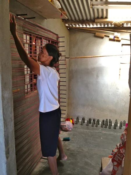The yarn for all the entire village is prepped in this single room. I call her Manang Spider Woman because she has to move left to right going up and down the wall one spike at a time. There are 24 spools of thread being used for this step (gray cones on the floor). The thread is rolled on bamboo sticks for the warp. 