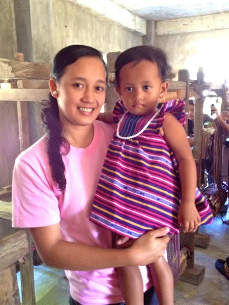 Ana is the 2nd youngest weaver in Abra. Her learning the craft is a testament to weaving's growth and potential. Her 2-year old daughter Natalie is wearing a Sugarcane dress.