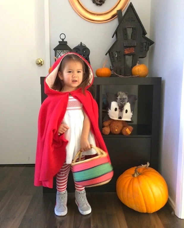 Part handmade, part ready-made. I sewed the cape and bought the dress from Janie and Jack. The high tops and leggings are from her closet. Cool Bear's beanie is gift from Aunt Ricci. She'd rather be the wolf though.