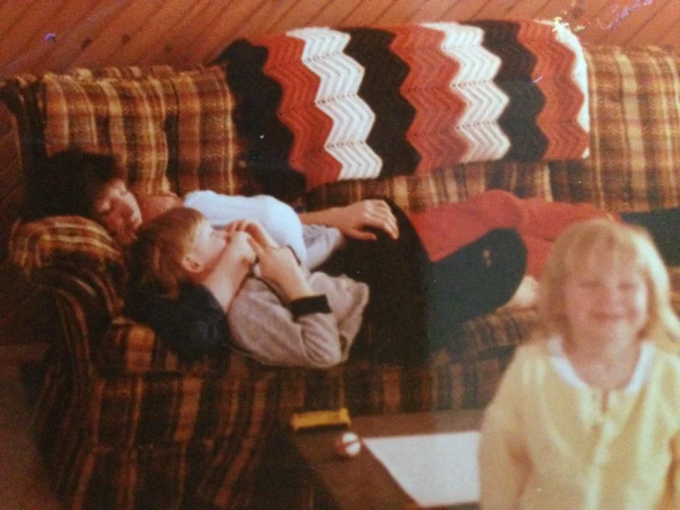 My mom cuddling with my brothers, and me cheesin' in the foreground. Typical. :)