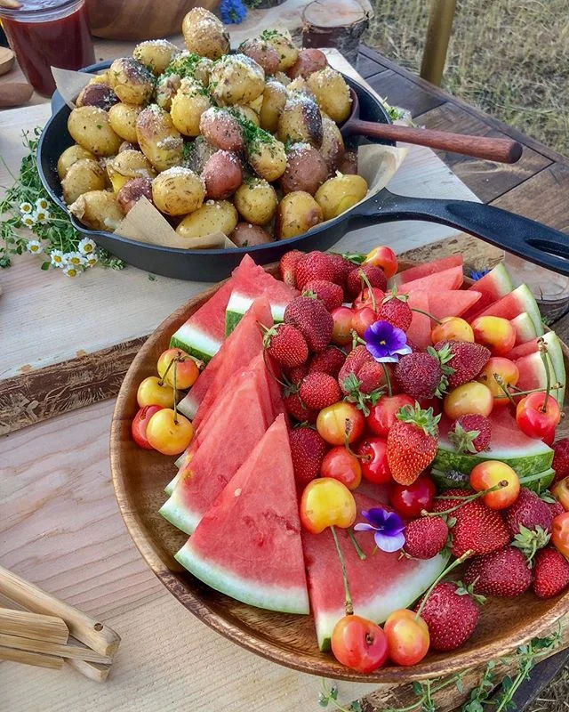 Our seasonal fruit platter is full of local strawberries &amp; Rainer cherries from the @downtownslc farmers market. 🍓🍒🍉 And those Dutch oven potatoes in the background are covered in a white wine butter sauce and sprinkled with summer herbs &amp;