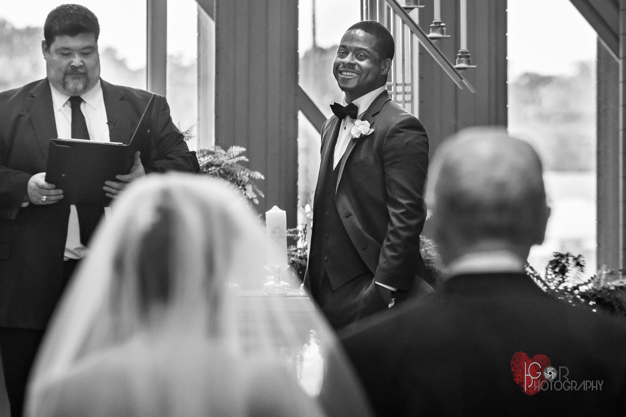 Groom watching the bride walking down the aisle