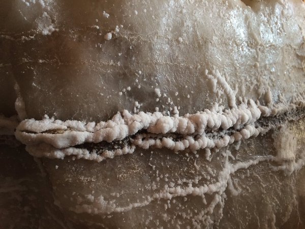 Salt crystals find a substrate to grow on, it's a vein of pyroclastic ash.