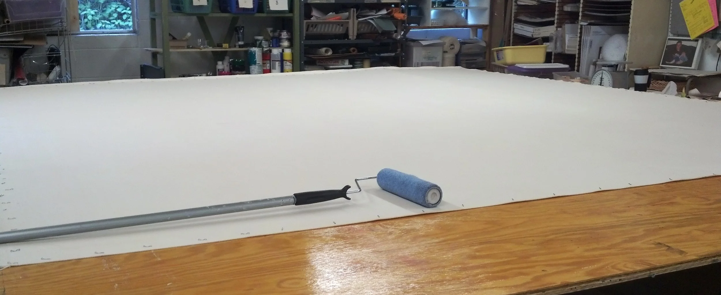 Shrinking and sizing the canvas prior to painting.