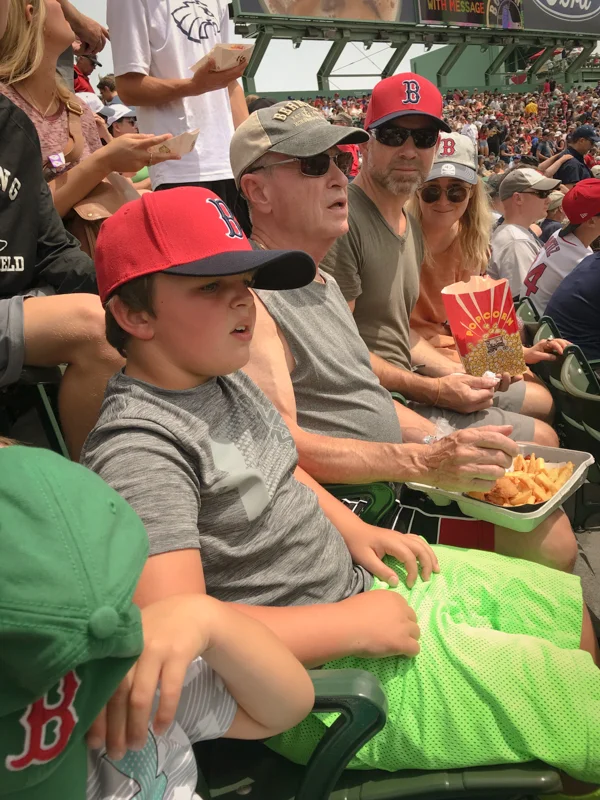 On the hottest day of the year Uncle Chris got us all tickets to the Red Sox game. That was really special. Can you see Jaxson hiding under the red B right there on the left. Everyone has their Red Sox hats on…to keep the sun out. I wonder what was happening on the field. You and Papa are so interested. Thank you Uncle Chris and Julia for this really special family day.