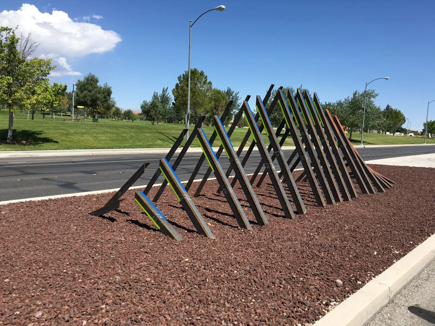arcSPINE | Clark County (2016) PUNCH Art Project: 30'-0"L x 5'-0"w x 9'-0"h steel angle sculpture that referenced the surround mountain as it slows rises from the ground. Each piece is cantilevered at an offset angle and none of the pieces touch. PUNCH Art is Zak Ostrowski, Drew Gregory, and Clemente Cicoria.
