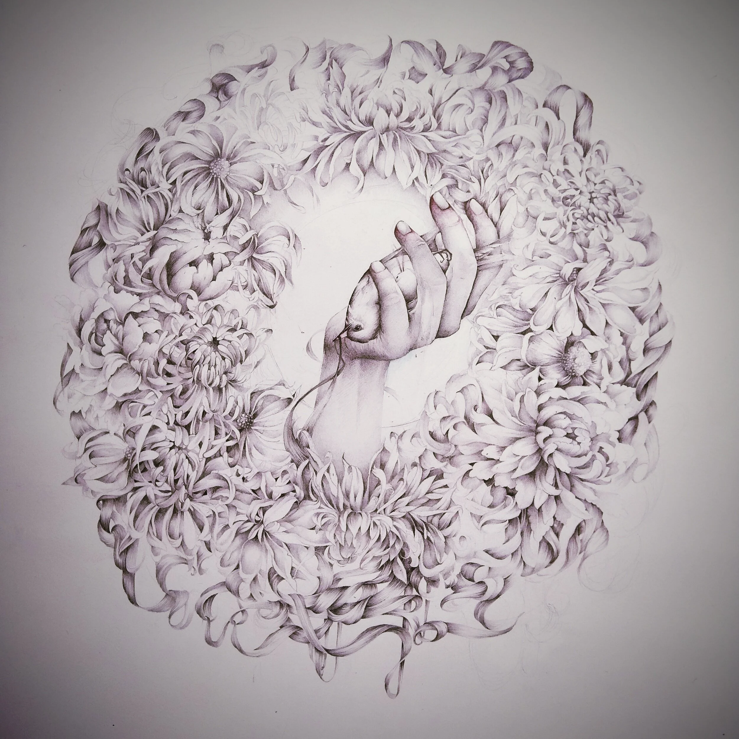 A detailed pencil sketch of a hand holding a human brain, surrounded by intricate flowers forming a circular frame.