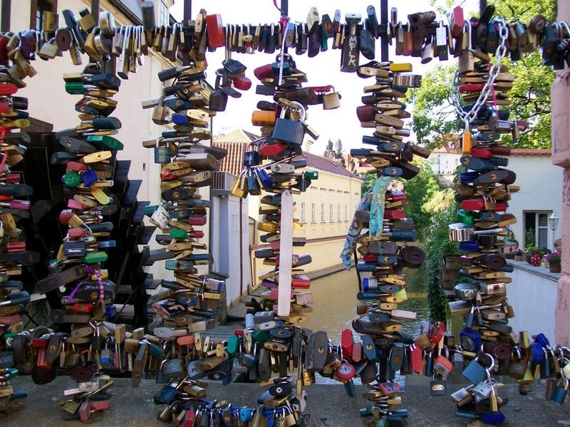 Prague love padlocks can in Malá Strana district on a small pedestrian bridge over a sidearm of the in front of a water wheel.