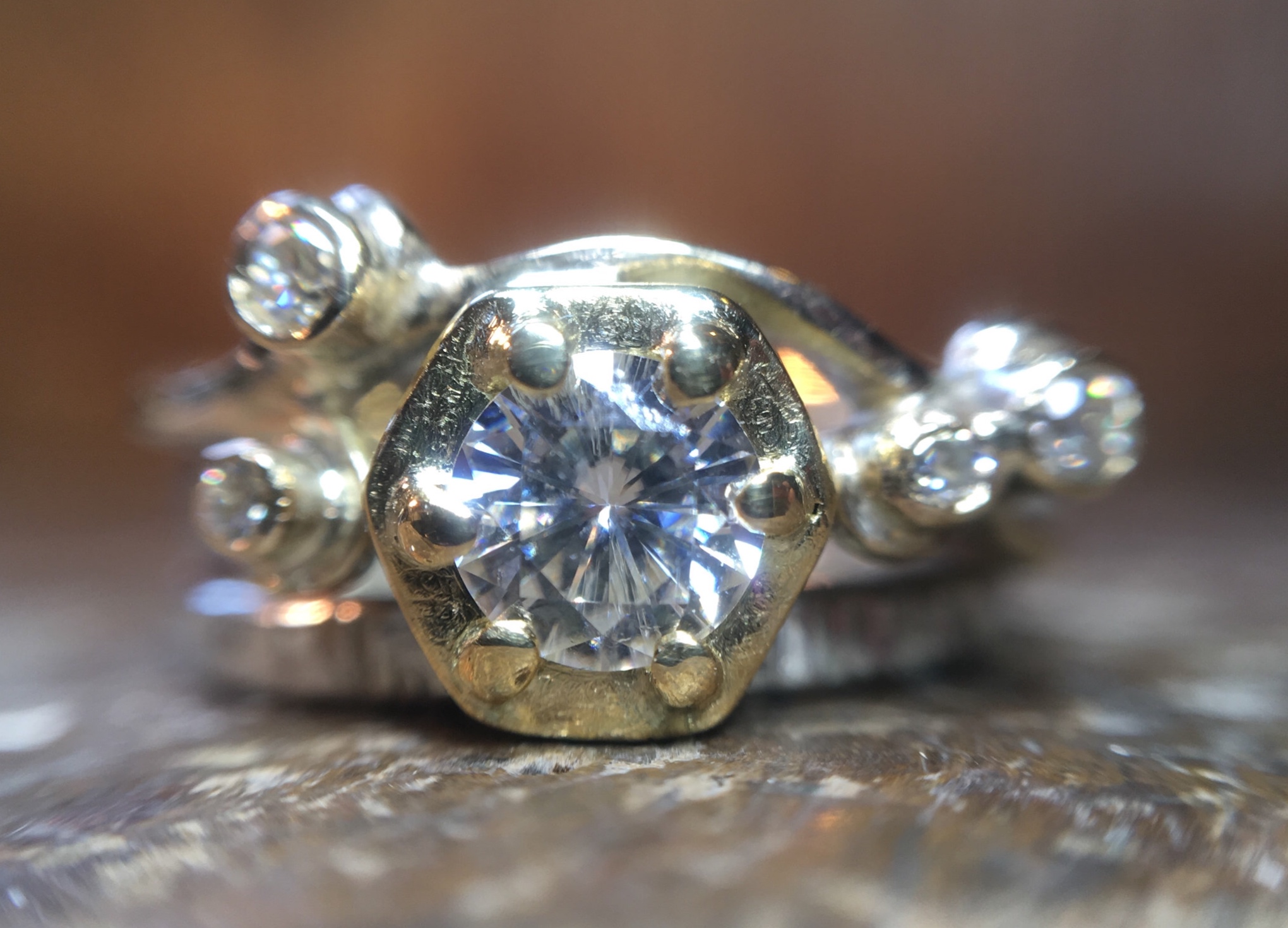 Yellow, white gold and moissanite in a hexagon setting