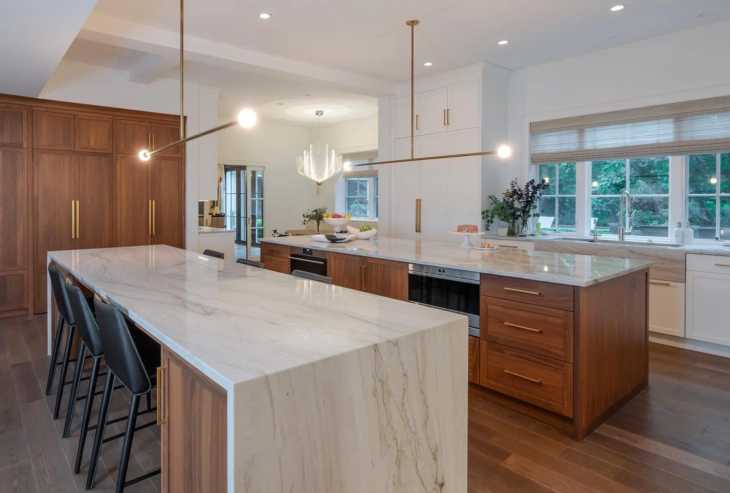 A sleek kitchen makeover with hidden pantry and double island from our recent Gladwyne project 

Architecture &amp; Design: Abby Schwartz Associates
Contractor: Cappelletti Custom Builders
Interior Design: L. Kate Interiors 
Cabinetry: Bluebell Fine 