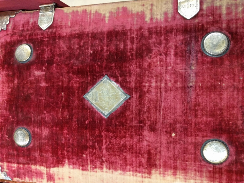 Close-up of the cover of the Bishops' Bible that was in Queen Elizabeth's private chapel, including her marks engraved on the clasps and other hardware.