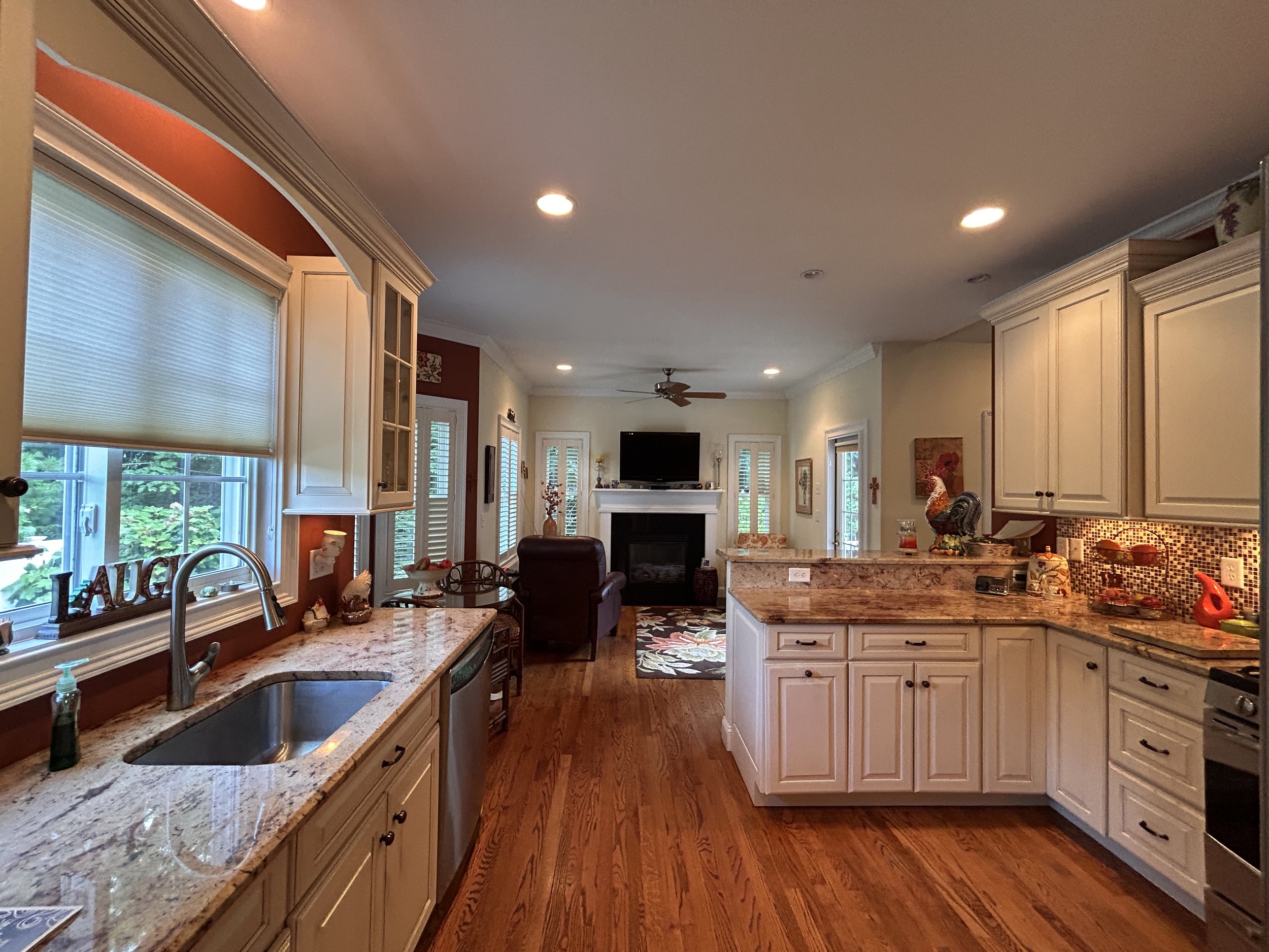 Kitchen looking towards bistro/sitting area with fireplace