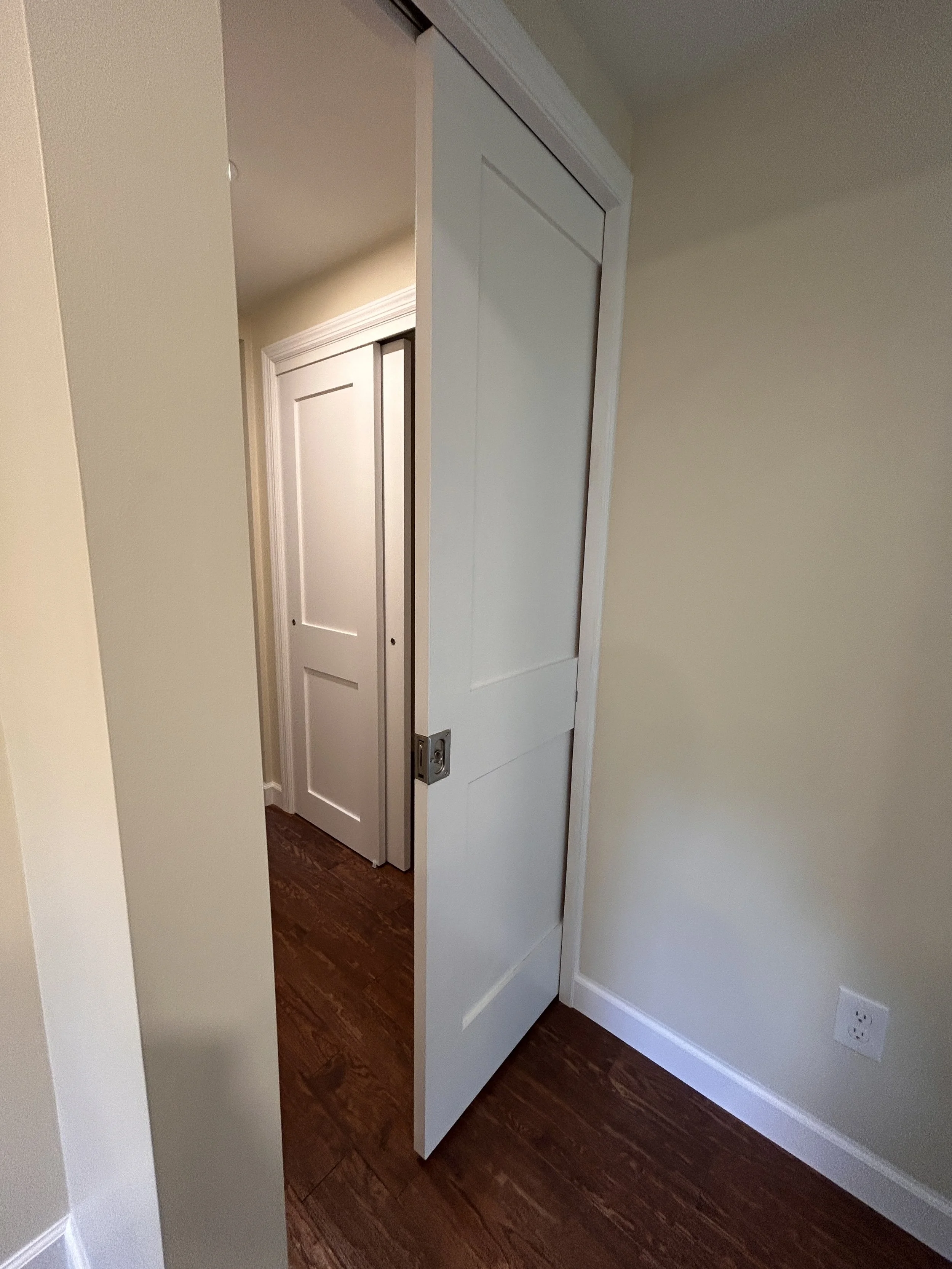 Privacy pocket door ahead of Primary Bedroom and Primary Bathroom Suites