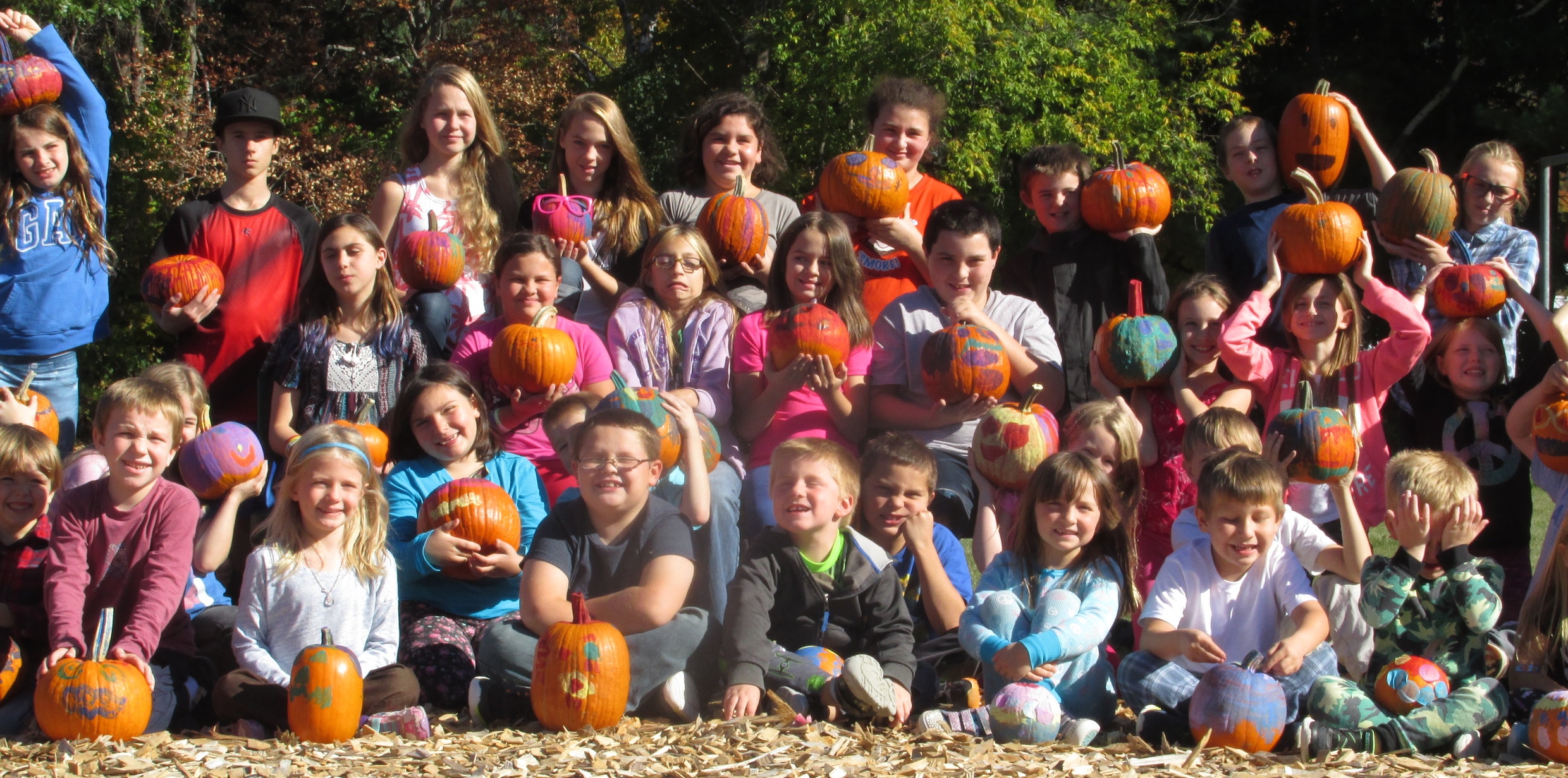 Currier Memorial Students with harvested -- and decorated -- pumpkins.
