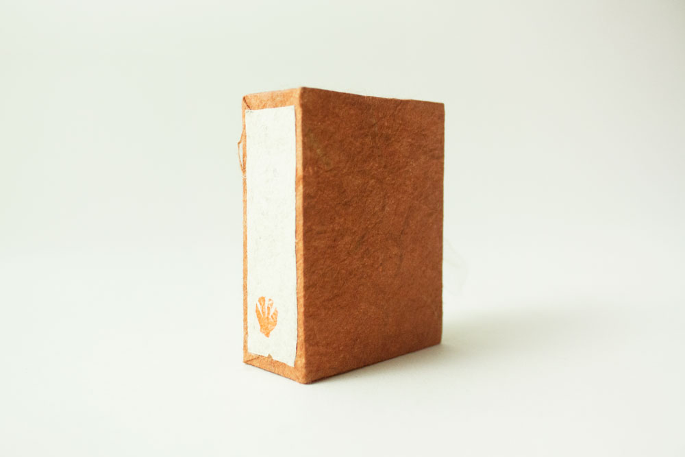 Hand craved stamp on the book case's spine.