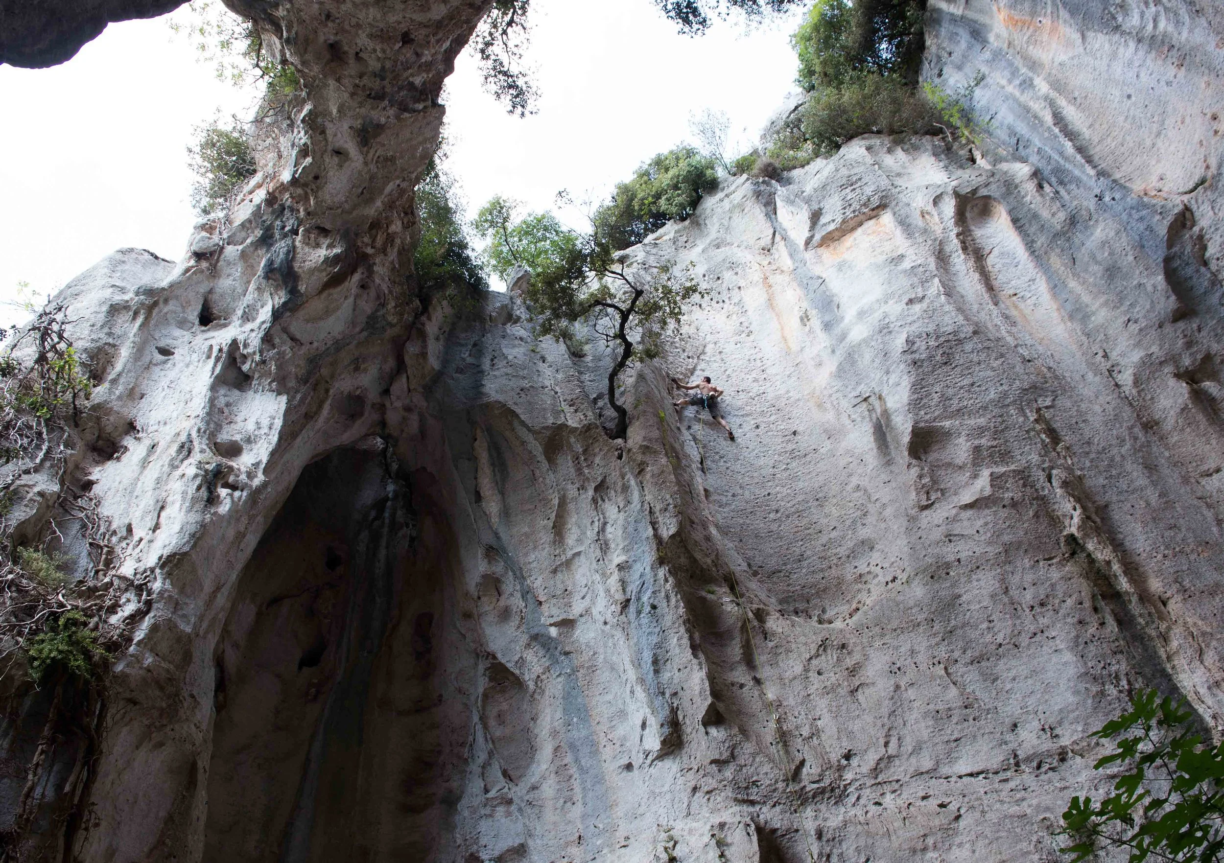 Giulio climbing a sturdy 6a warm up in the open roof cave.