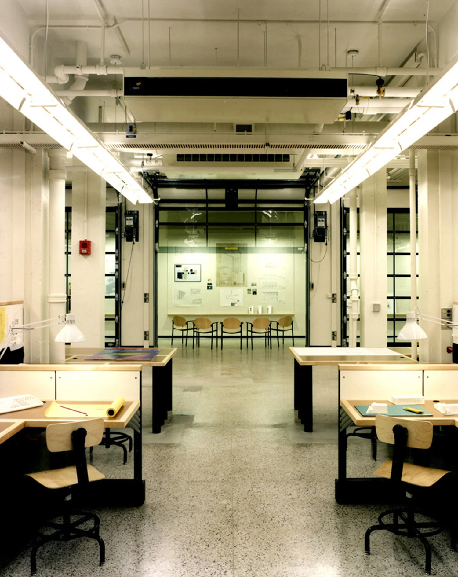 Massachusetts Institute of Technology (MIT), School of Architecture Architecture Studios, Faculty Offices, Classrooms, Meeting Spaces Size: 60,000 sf The transition from traditional drafting to CADD required MIT to completely reinvent their teaching environments and faculty offices. Assisting architects Leers, Weinzapfel and Associates, the firm developed a new prototype centered on fully and flexibly wired studios that could handle student abuse, reconfigure easily, allow student personalization, and support both traditional and computerized learning modalities. Working directly with suppliers and installers, the firm explored a number of design options before proposing to customize Herman Miller Ethospace workstations to meet the College’s needs. By stripping the system of all cosmetic elements, outfitting it with solid wood counters and basic tackable surfaces, and field testing the result to prove that two grown men could safely jump on the counters, the firm convinced MIT to proceed with the first installation. Success of the prototype subsequently led to full adoption by the School of Architecture. Interior Design: Polly Dithmer and Roel Krabbendam Architecture: Leers, Weinzapfel and Associates, Inc.
