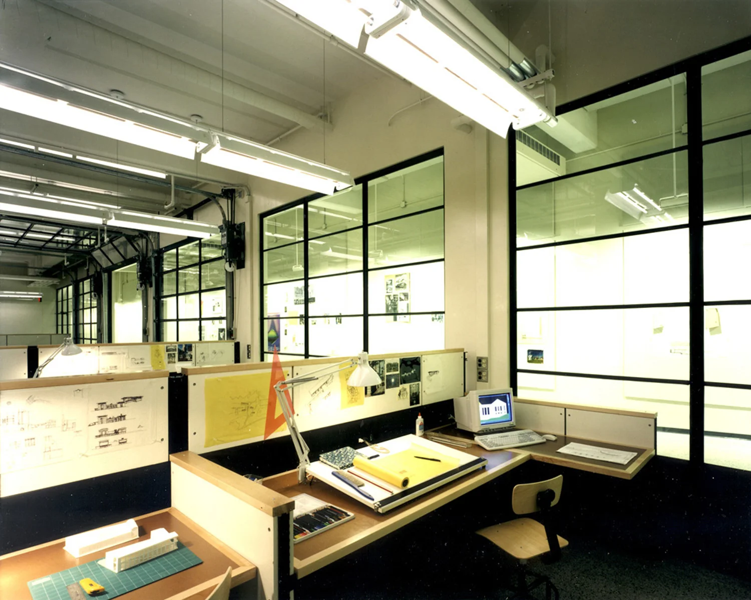 Massachusetts Institute of Technology (MIT), School of Architecture Architecture Studios, Faculty Offices, Classrooms, Meeting Spaces Size: 60,000 sf The transition from traditional drafting to CADD required MIT to completely reinvent their teaching environments and faculty offices. Assisting architects Leers, Weinzapfel and Associates, the firm developed a new prototype centered on fully and flexibly wired studios that could handle student abuse, reconfigure easily, allow student personalization, and support both traditional and computerized learning modalities. Working directly with suppliers and installers, the firm explored a number of design options before proposing to customize Herman Miller Ethospace workstations to meet the College’s needs. By stripping the system of all cosmetic elements, outfitting it with solid wood counters and basic tackable surfaces, and field testing the result to prove that two grown men could safely jump on the counters, the firm convinced MIT to proceed with the first installation. Success of the prototype subsequently led to full adoption by the School of Architecture. Interior Design: Polly Dithmer and Roel Krabbendam Architecture: Leers, Weinzapfel and Associates, Inc.