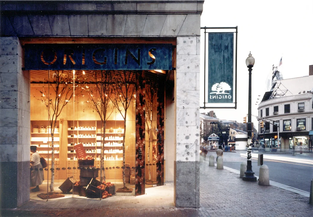 Origins Prototype Store Estee Lauder Company The international brand requests a new store prototype to support their new line of cosmetics. A location on Harvard Square in Cambridge, Massachusetts provides the physical location for this exploration of the new product line. The commission is solved with both display and storage wrought in a reduced palette of maple, copper, stone and glass, amplifying the brand's allegiance to natural materials. The palette and branding was carried forward into a now well-known and successful network of mall and department store outlets. Interior Designer: Polly Dithmer Office of Record: Peter Forbes and Associates, Inc.