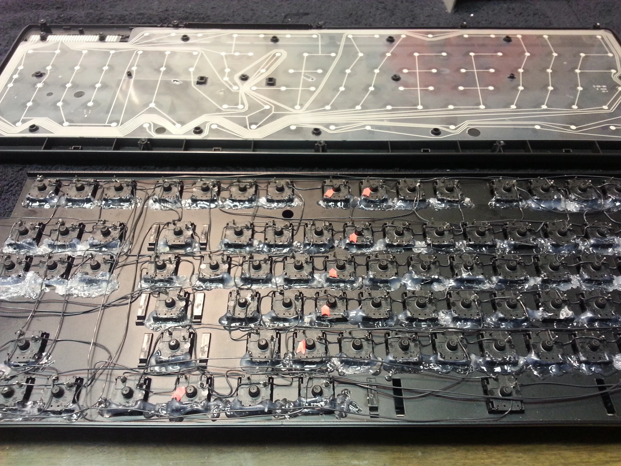 Mapping one continuous run of keys from the wireless membrane to the mechanical switches using red inspection arrows