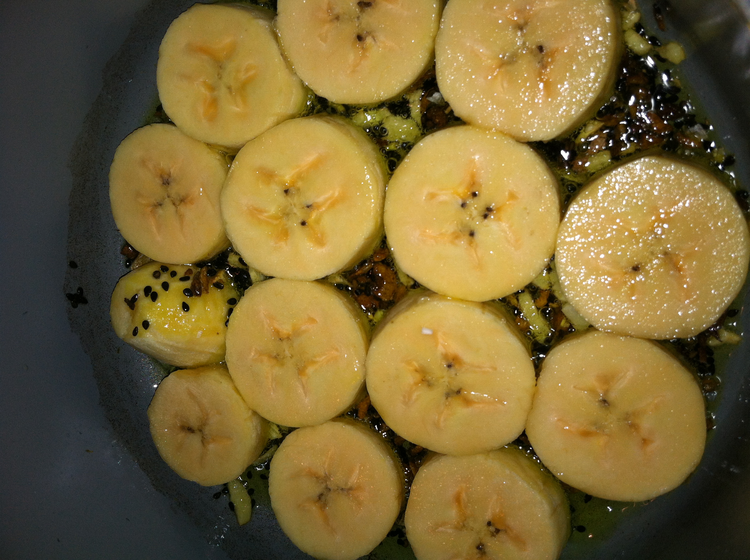 The Plantains soaking up the flavor and aromas from the Sesame Seeds, Garlic and Turmeric.