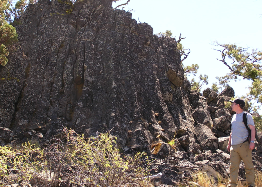  Kieran McCann stands next to a dike formation found near Mt. Rosebud. Photo by Jad D’Allura 