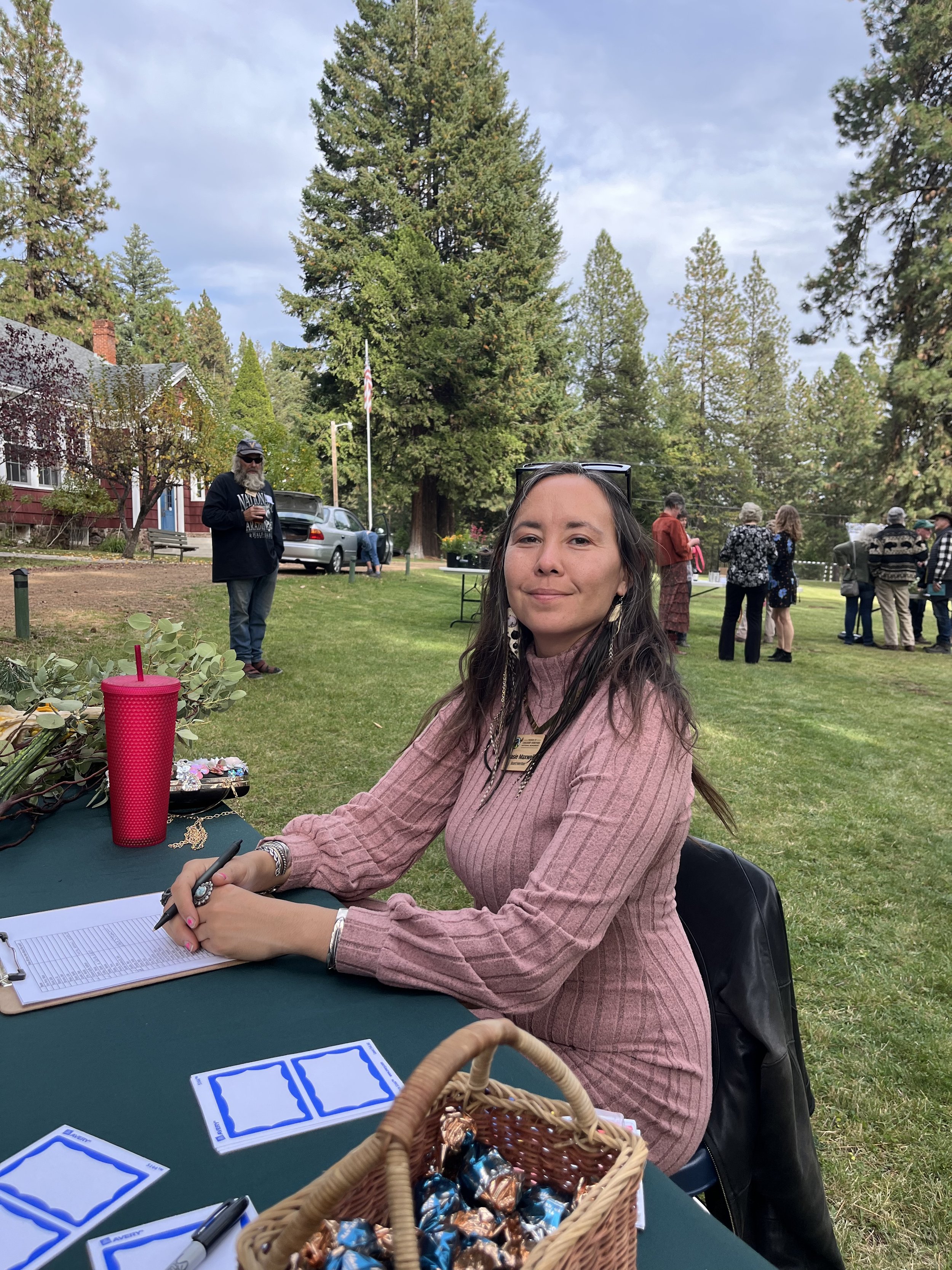 Stasie Maxwell, board secretary, greeting attendees at the welcome table.