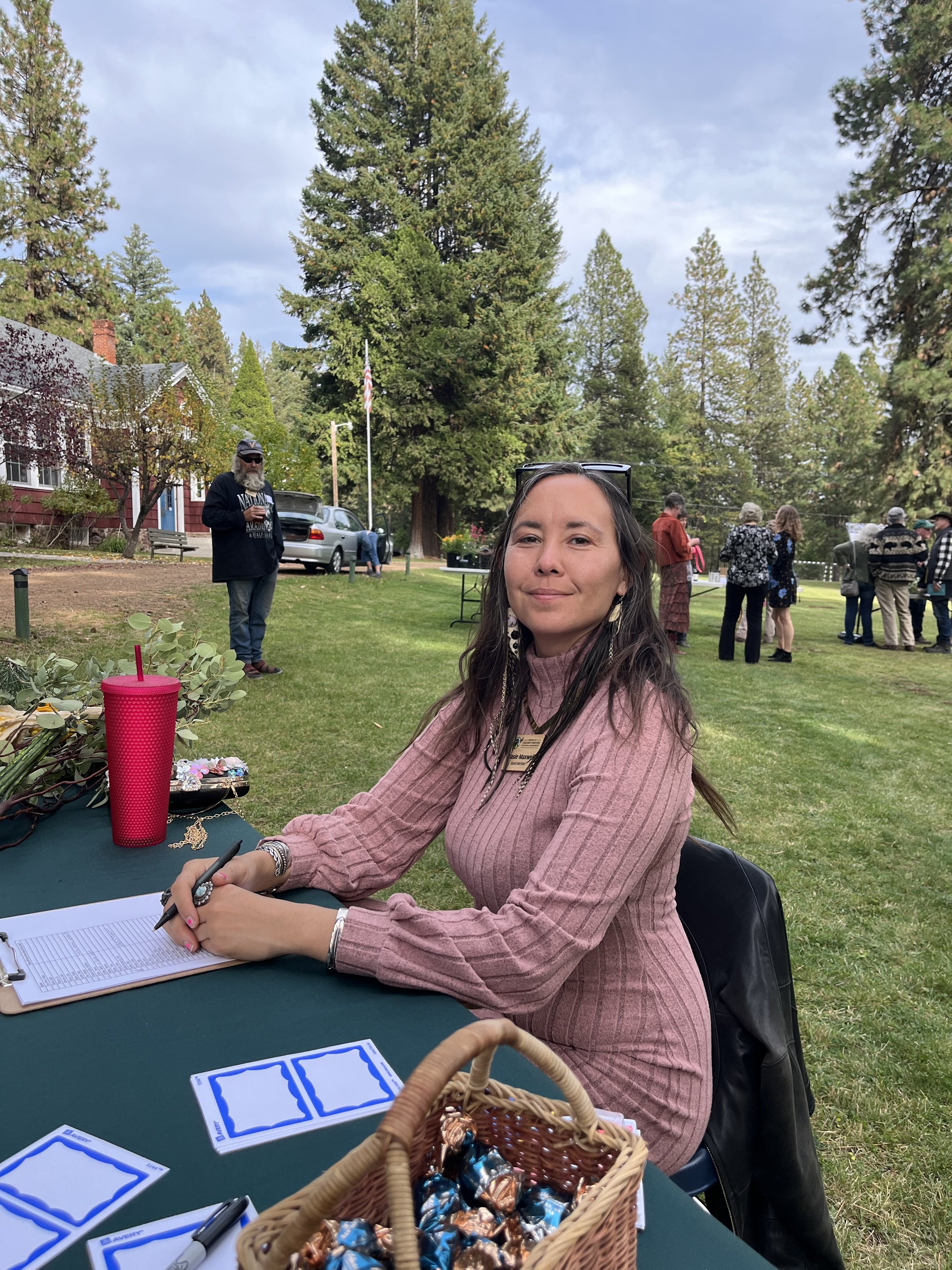   Stasie Maxwell, board secretary, greeting attendees at the welcome table.  