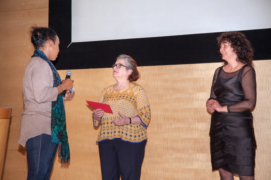 Debra Surkin handing the scholarships to Sarai T. Smith-Mazariegos.