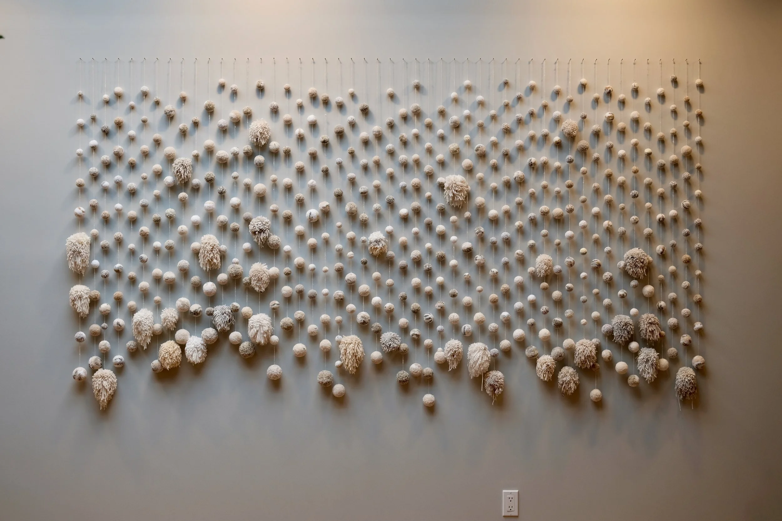 Wall hanging by textile artist Dana Haim greets arriving visitors.