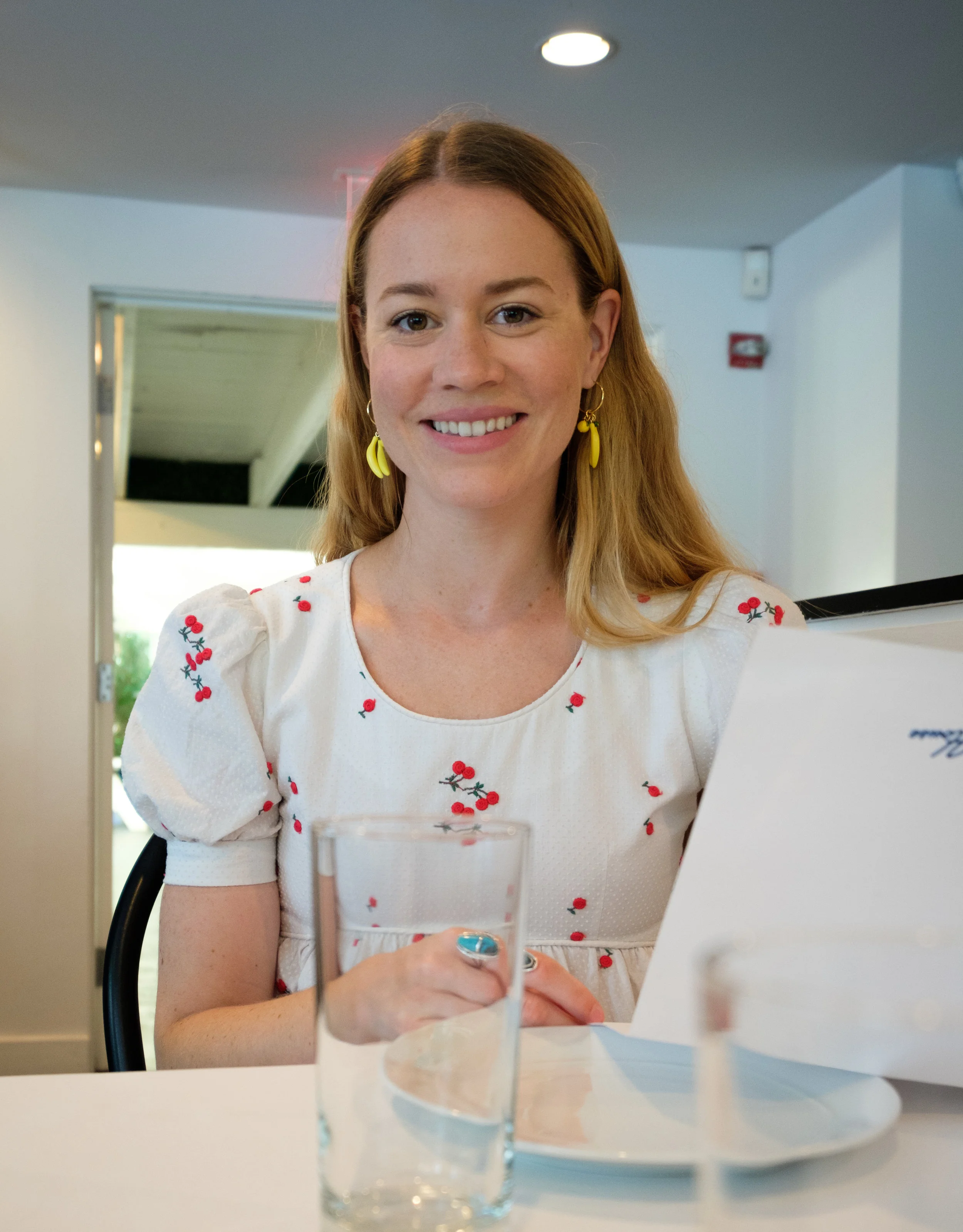 Anxiously awaiting our meal wearing the Vintage Cherry dress & J.Crew banana earrings .