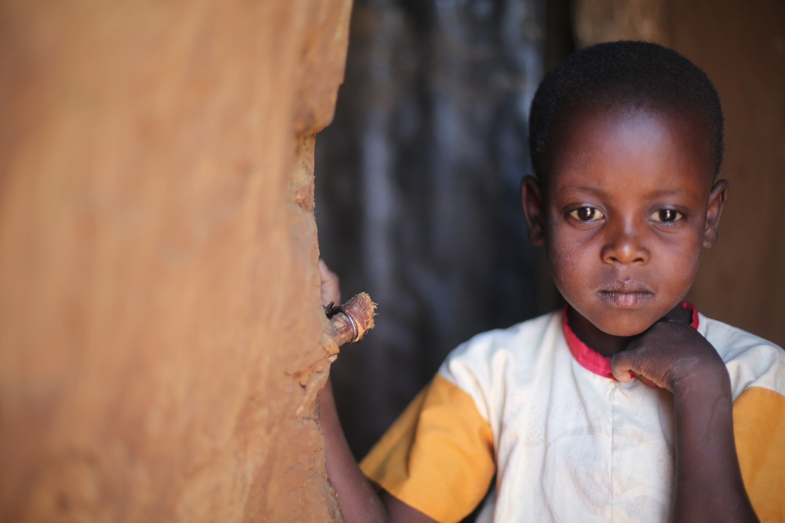 A young Maasai girl in the door way to her manyatta in Kenya