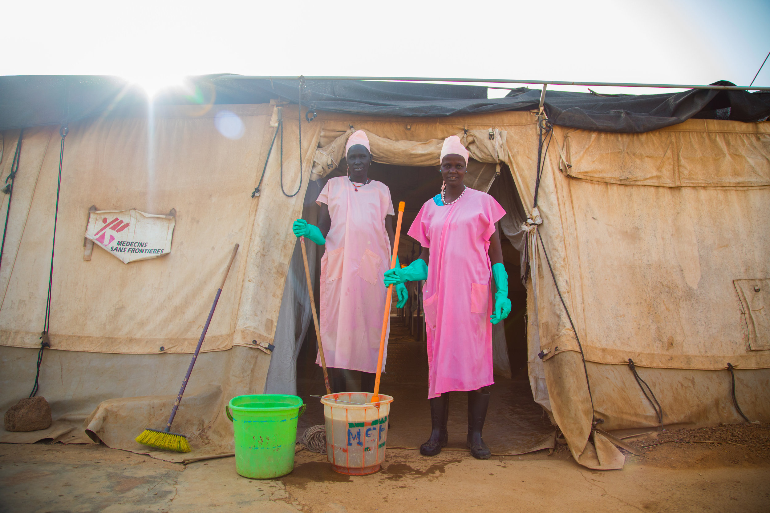 Two cleaners outside an MSF run hospital in Aweil, South Sudan