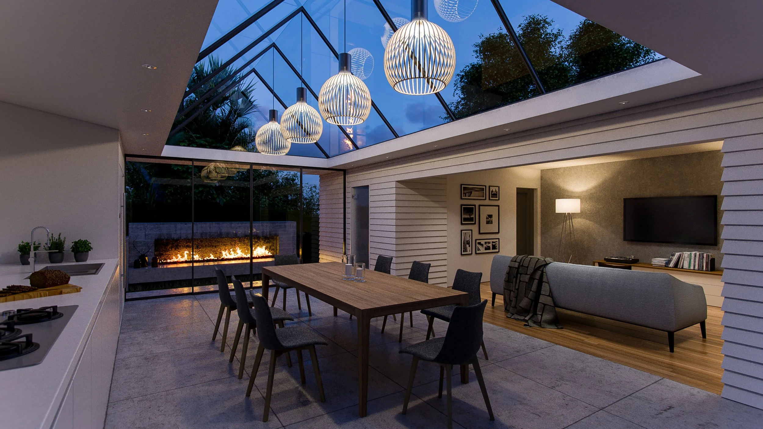 A contemporary glass atrium to an old cottage with an view to the outdoor landscape and fireplace.