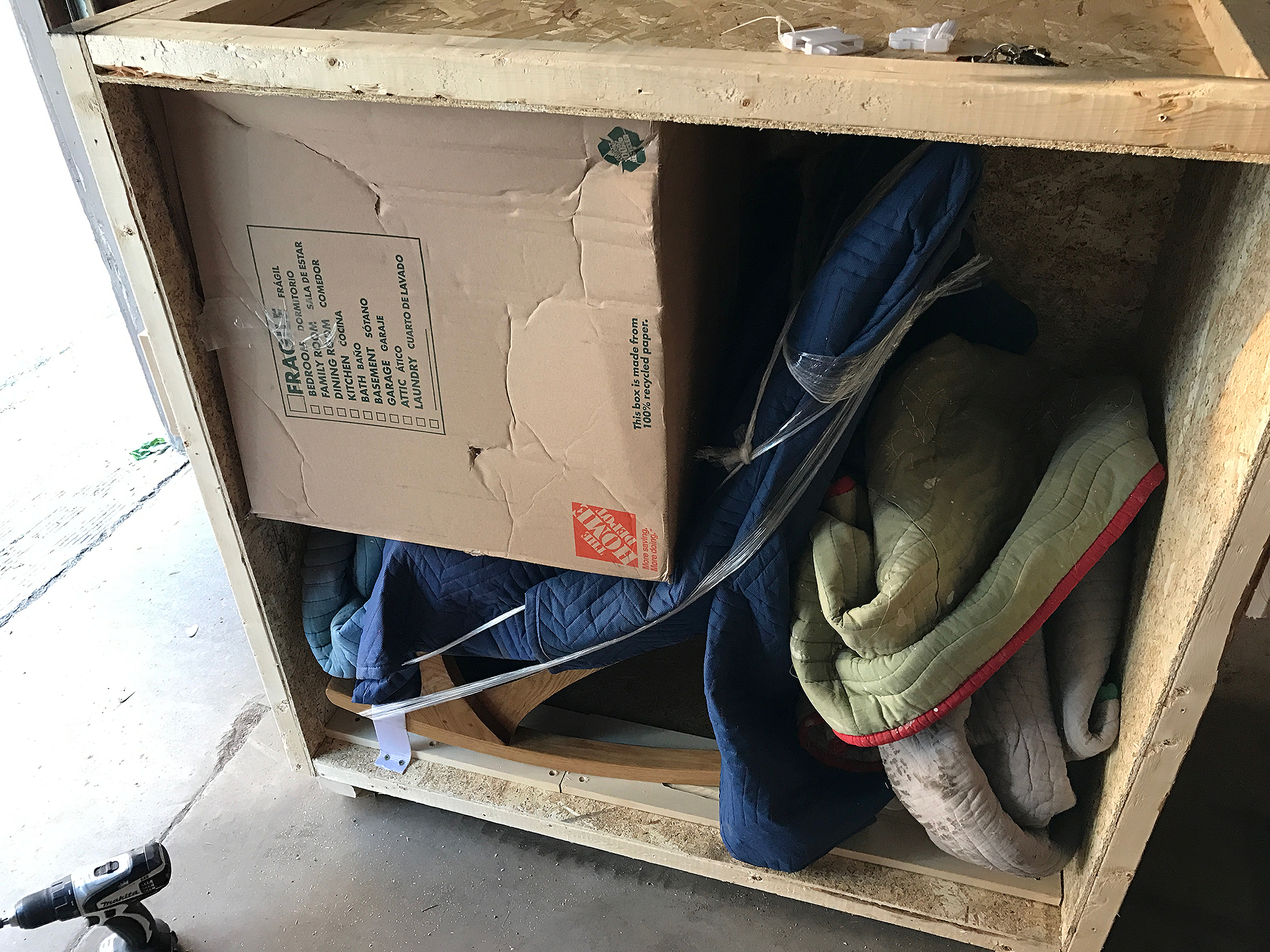 filling in the empty space with blankets and an empty cardboard box