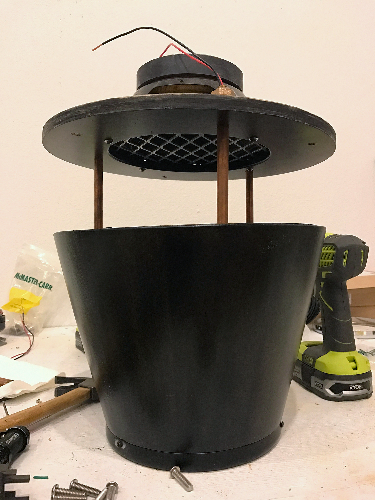 wiring runes through the brass tube to connect the two speakers