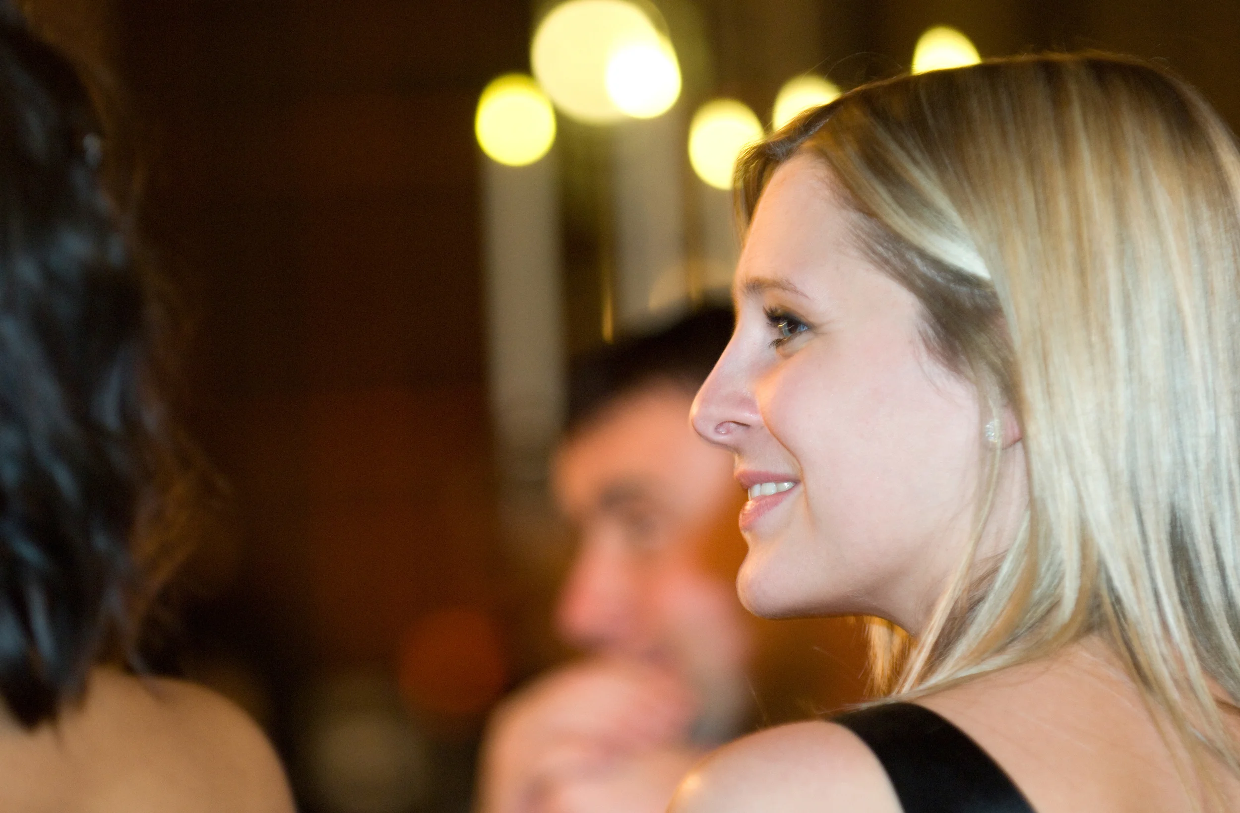 Candid portrait of a woman smiling at a black tie evening event