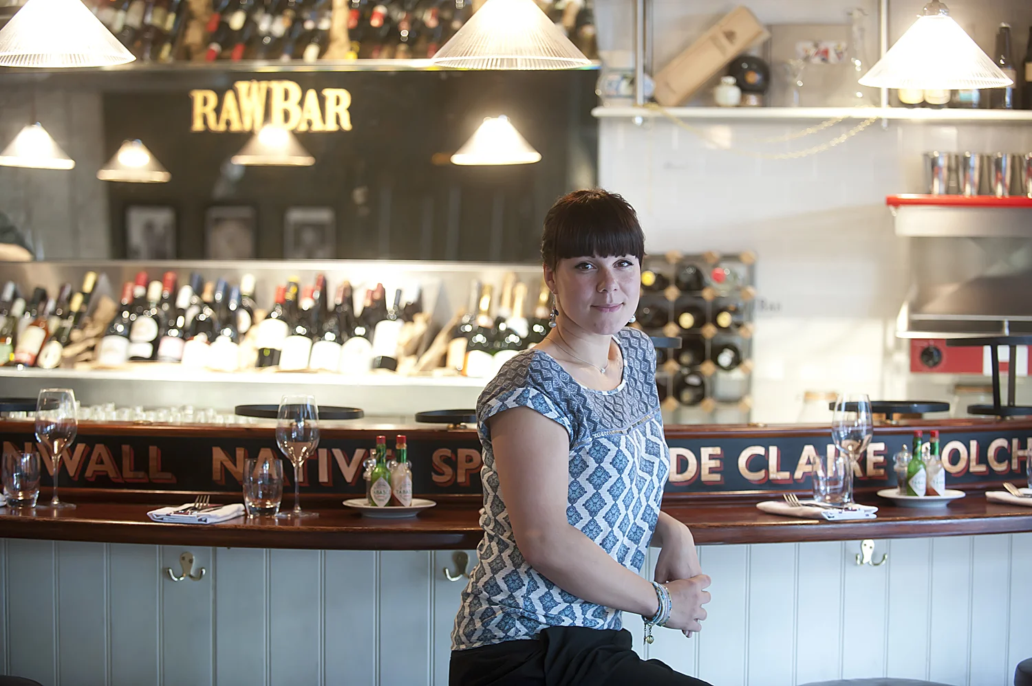 Portrait of waitress sitting at the bar in a London Oyster Restaurant