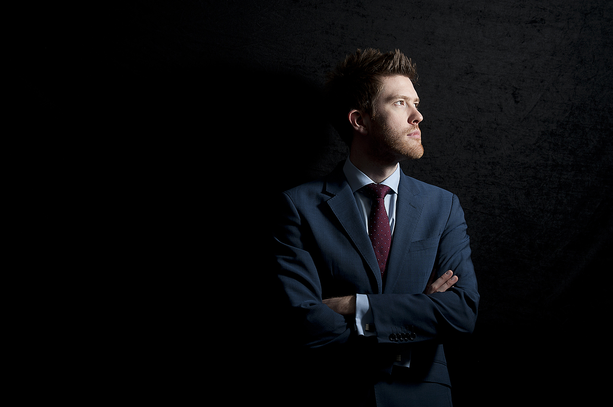 Portrait of a businessman in a suit in London with dramatic lighting