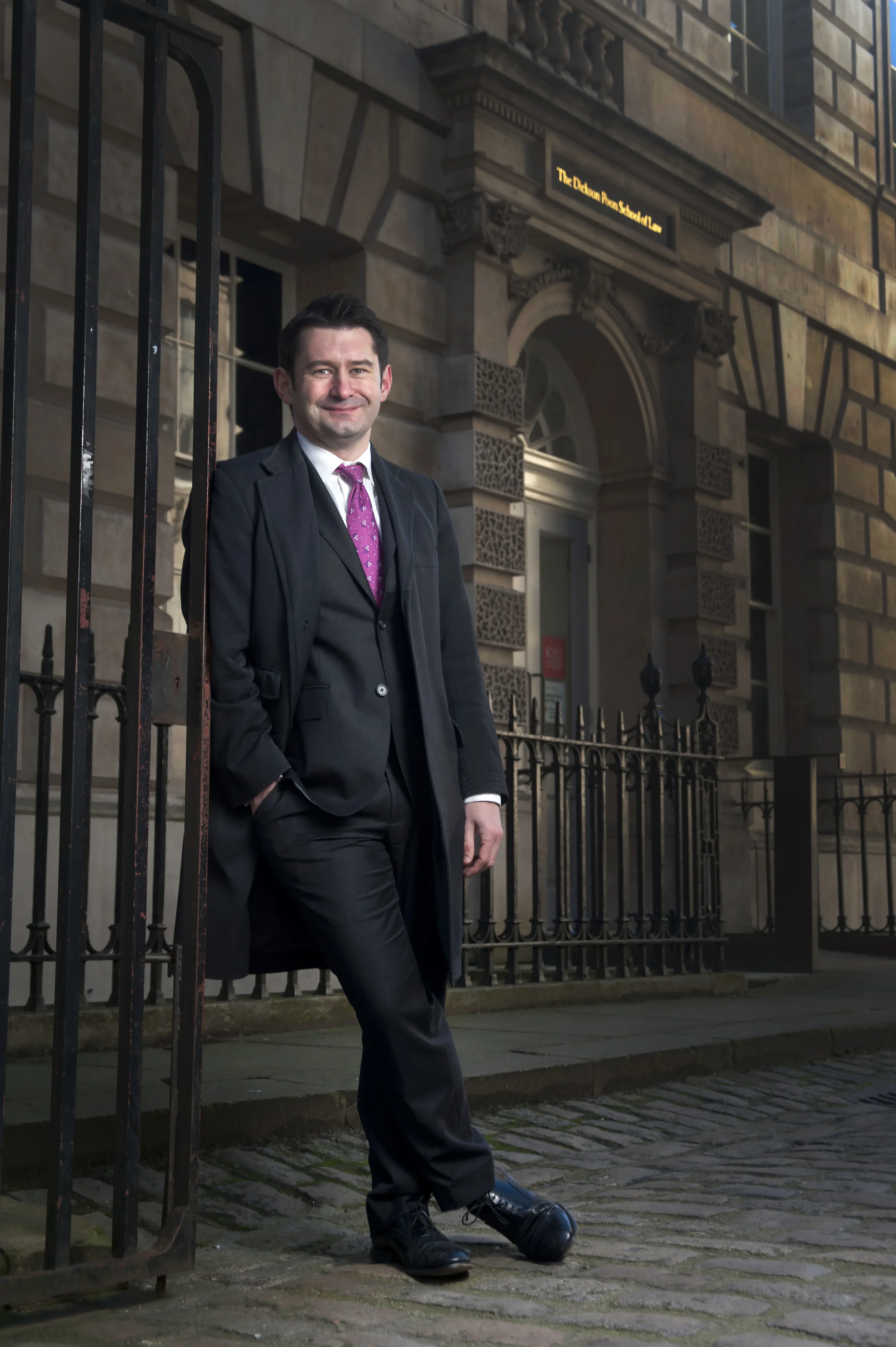 Portrait photography of a man in a suit outside Kings College London