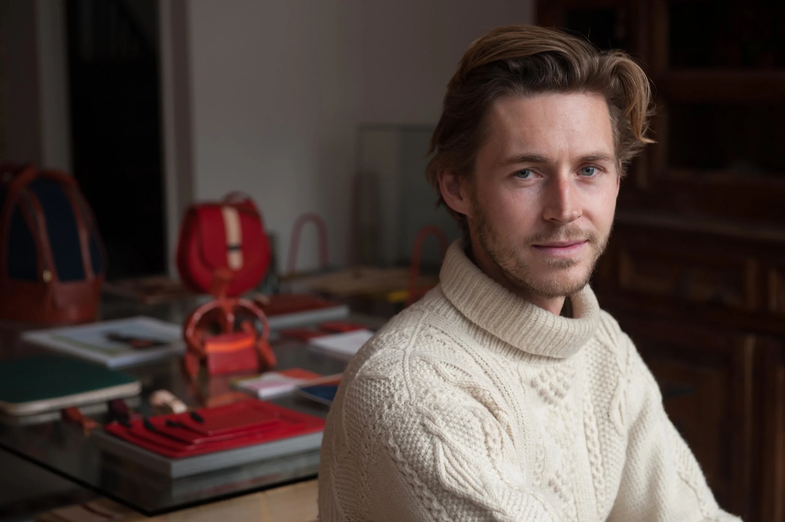 Portrait of a man in front of leather bags