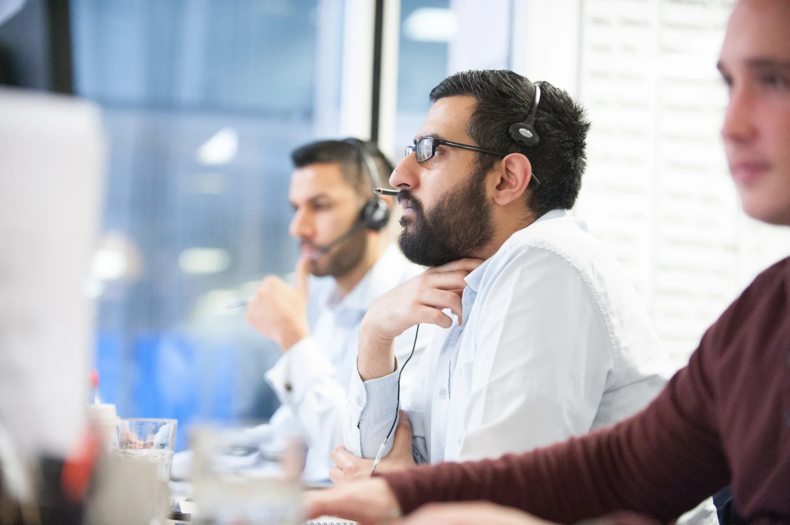 Reportage style portrait of a man with a beard on the phone in an office