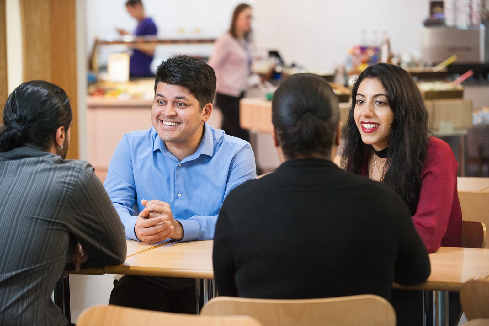 Employees talking in a staff canteen