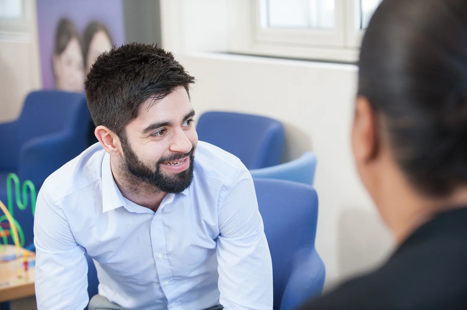 Candid Portrait of a businessman with a beard laughing in an office