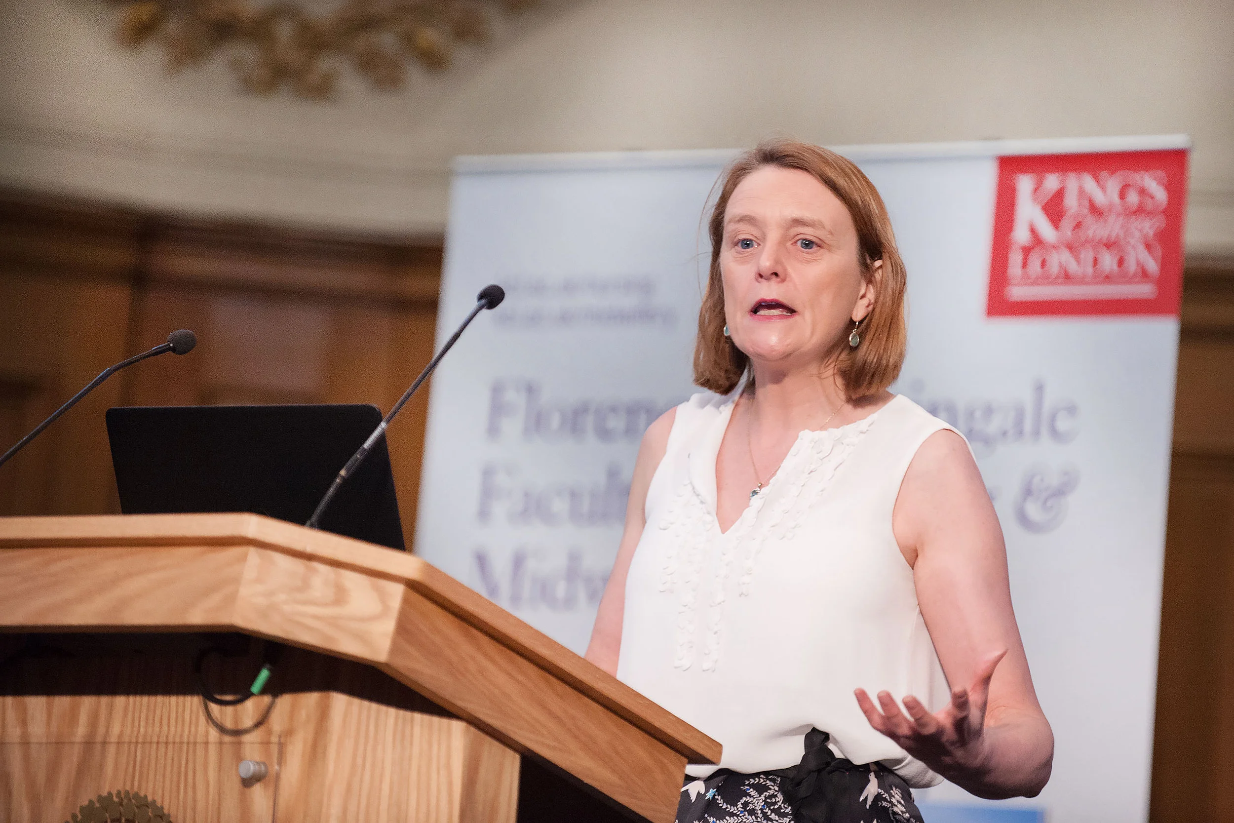 Speaking shot of a woman speaking at an event for Kings College London
