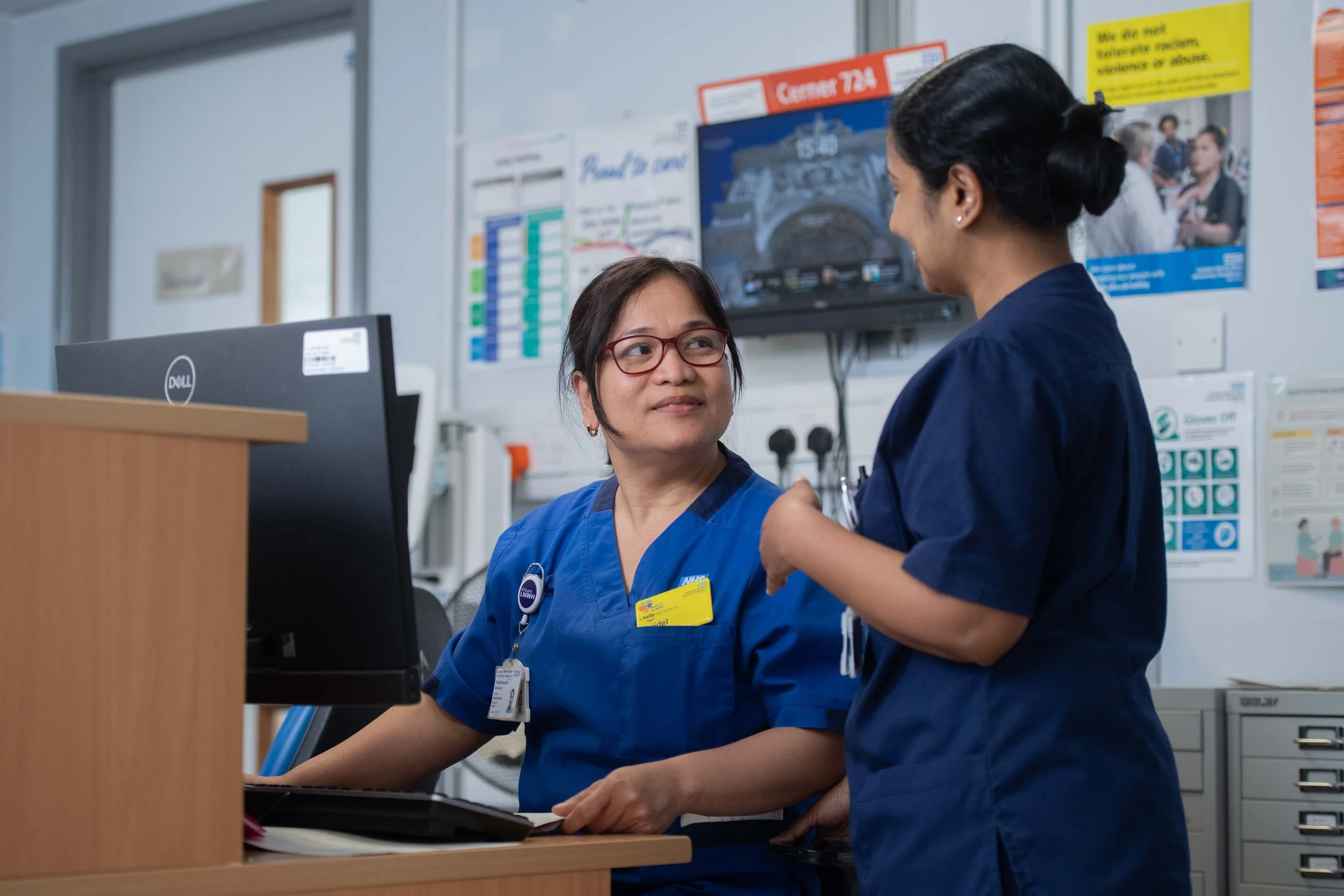 Nurses Talking at a Hospital Nurses’ Station