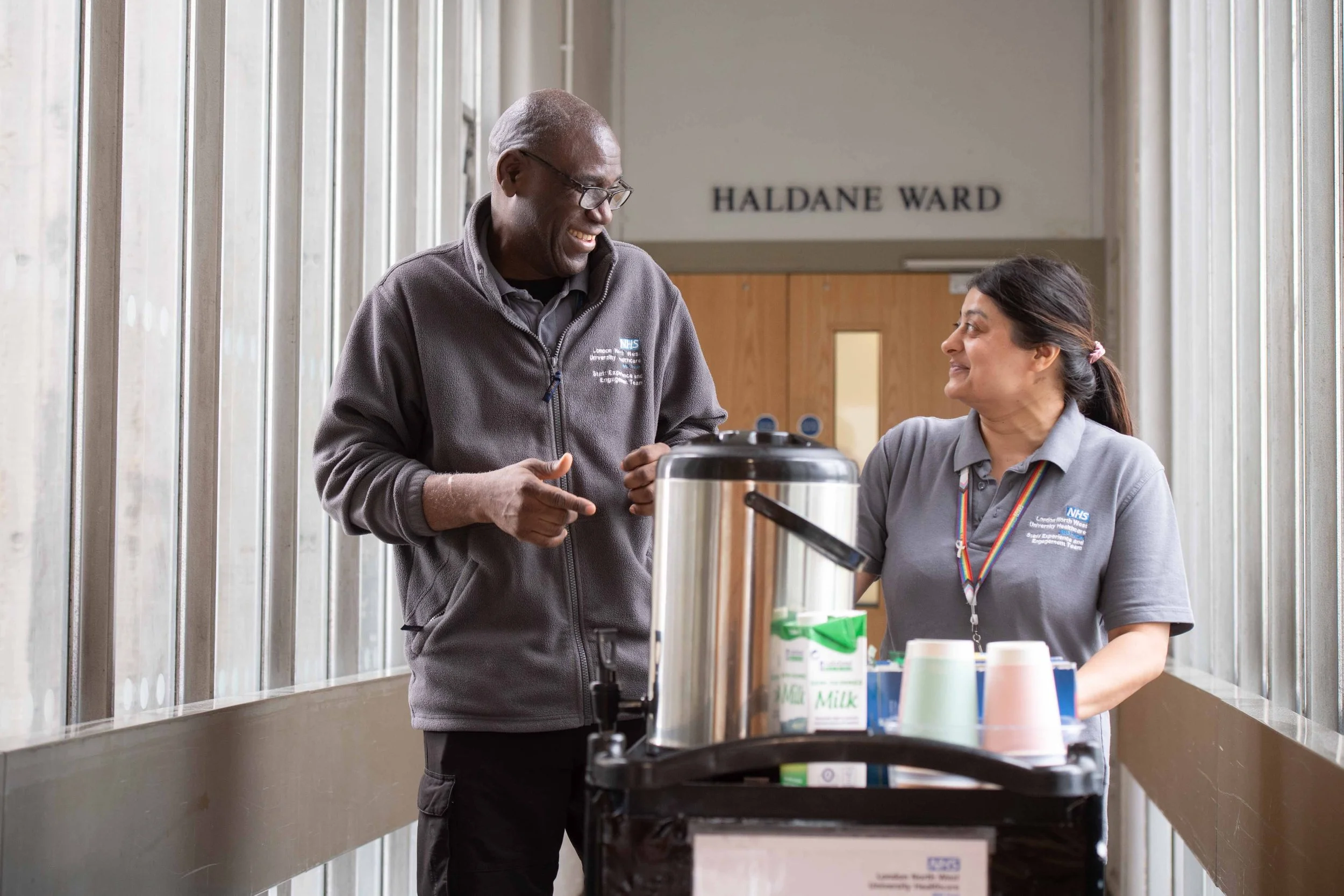 Hospital Catering Staff Walking with a Tea Trolley