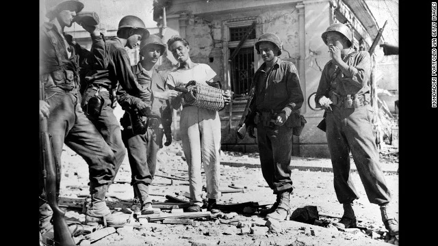 A Sicilian offering soldiers wine during WWII.